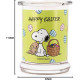 Bougie Peanuts Happy Easter aux notes d’ozone de pomme, orange musquée et jasmin, pour une atmosphère printanière et joyeuse.